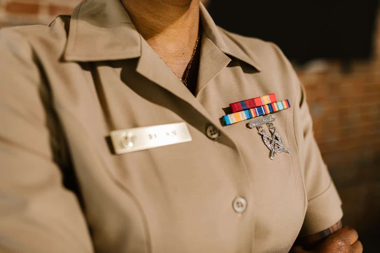 A detailed shot of a military uniform displaying medals and identification badges representing achievement and honor.